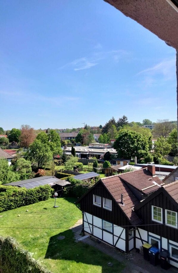 A residential area with a house featuring a sloped roof and a visible chimney.
