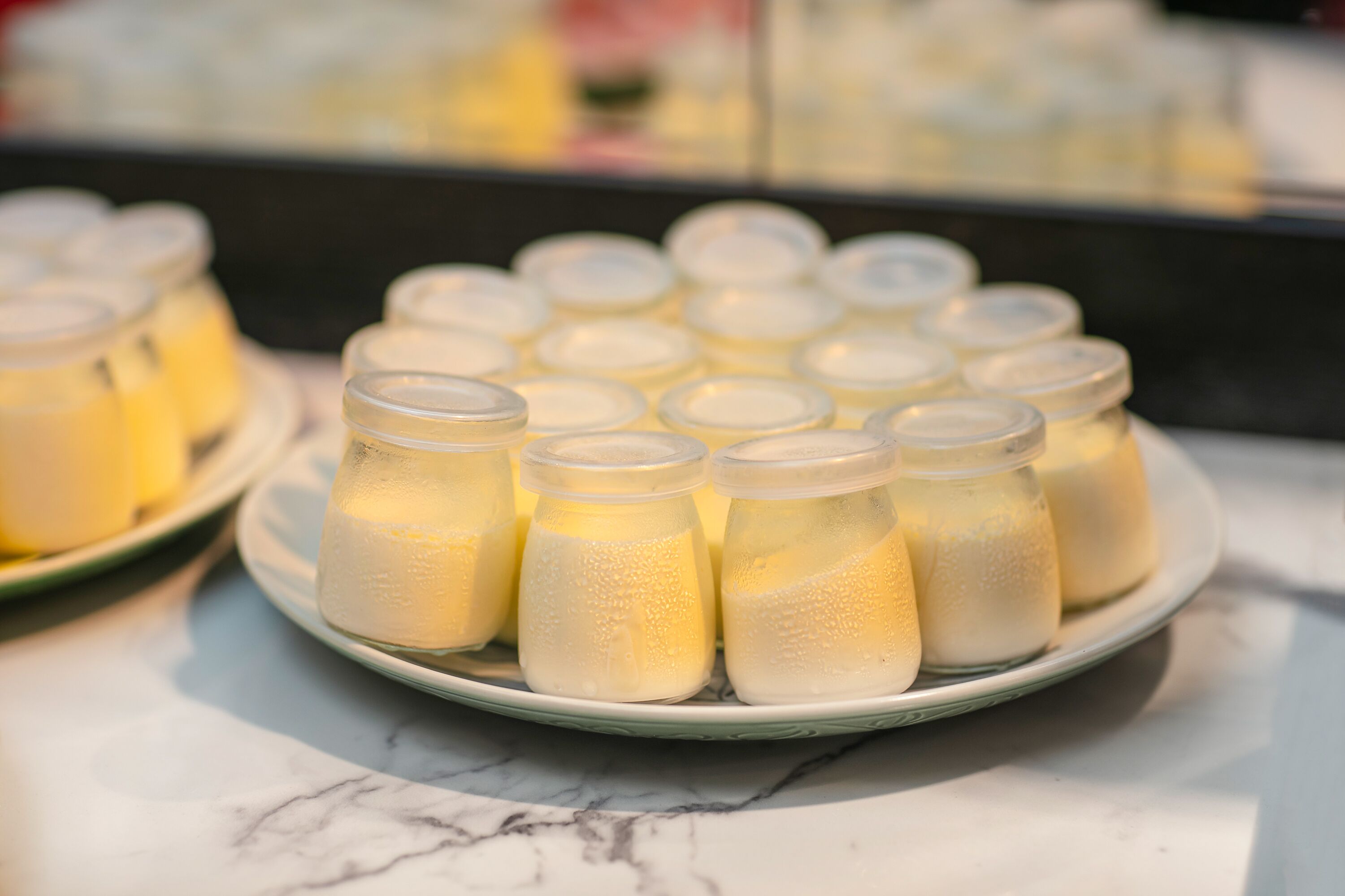 A plate of milk bottles on a marble surface.