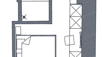 A floor plan with a large central room, a smaller room with a door, and a bathroom.