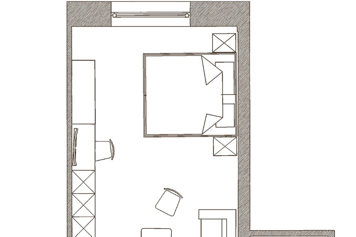Un plano de planta que muestra una cocina, comedor, dos dormitorios y un baño.