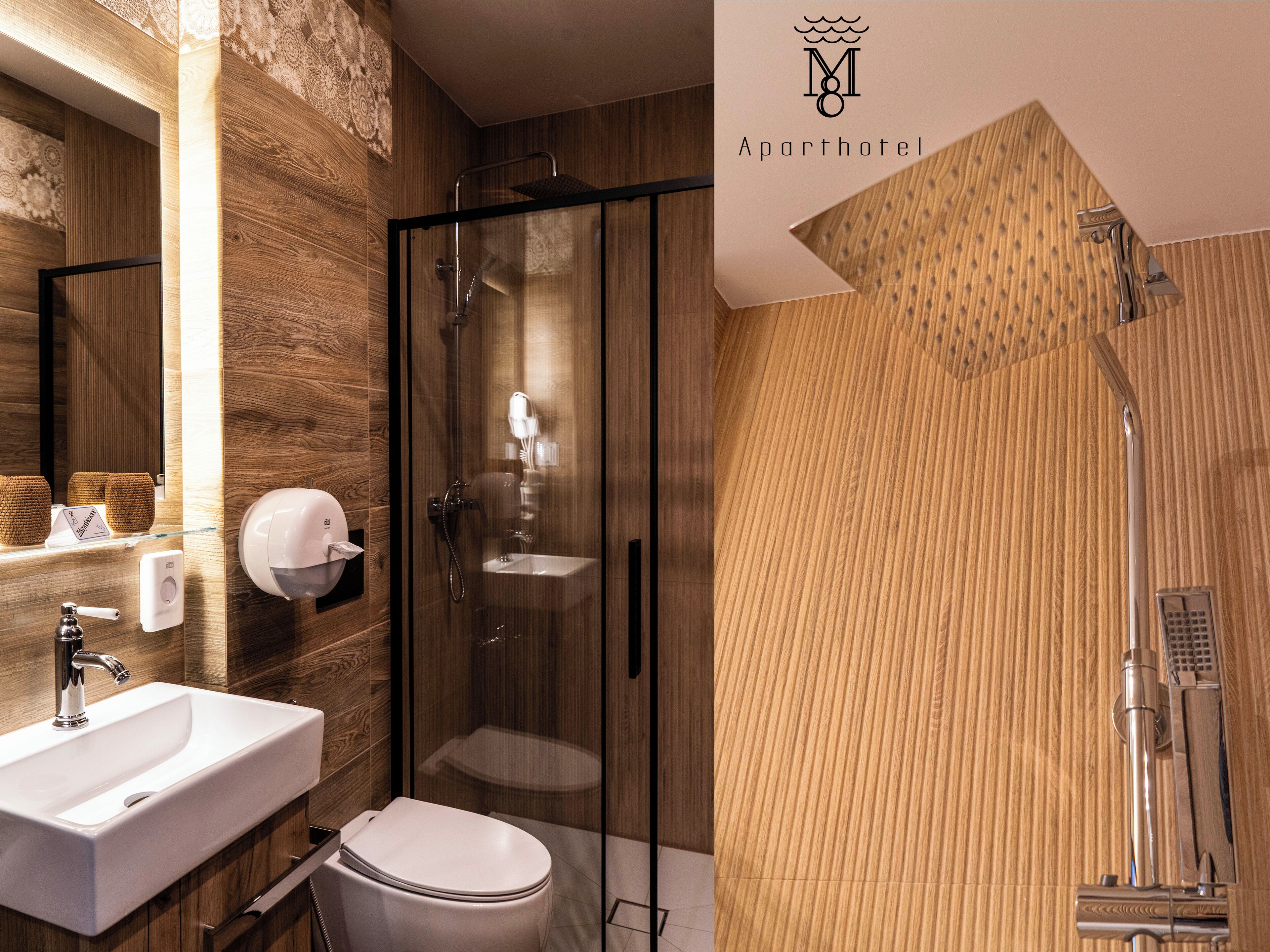 A modern bathroom with a glass-enclosed shower, a white sink, and a toilet.
