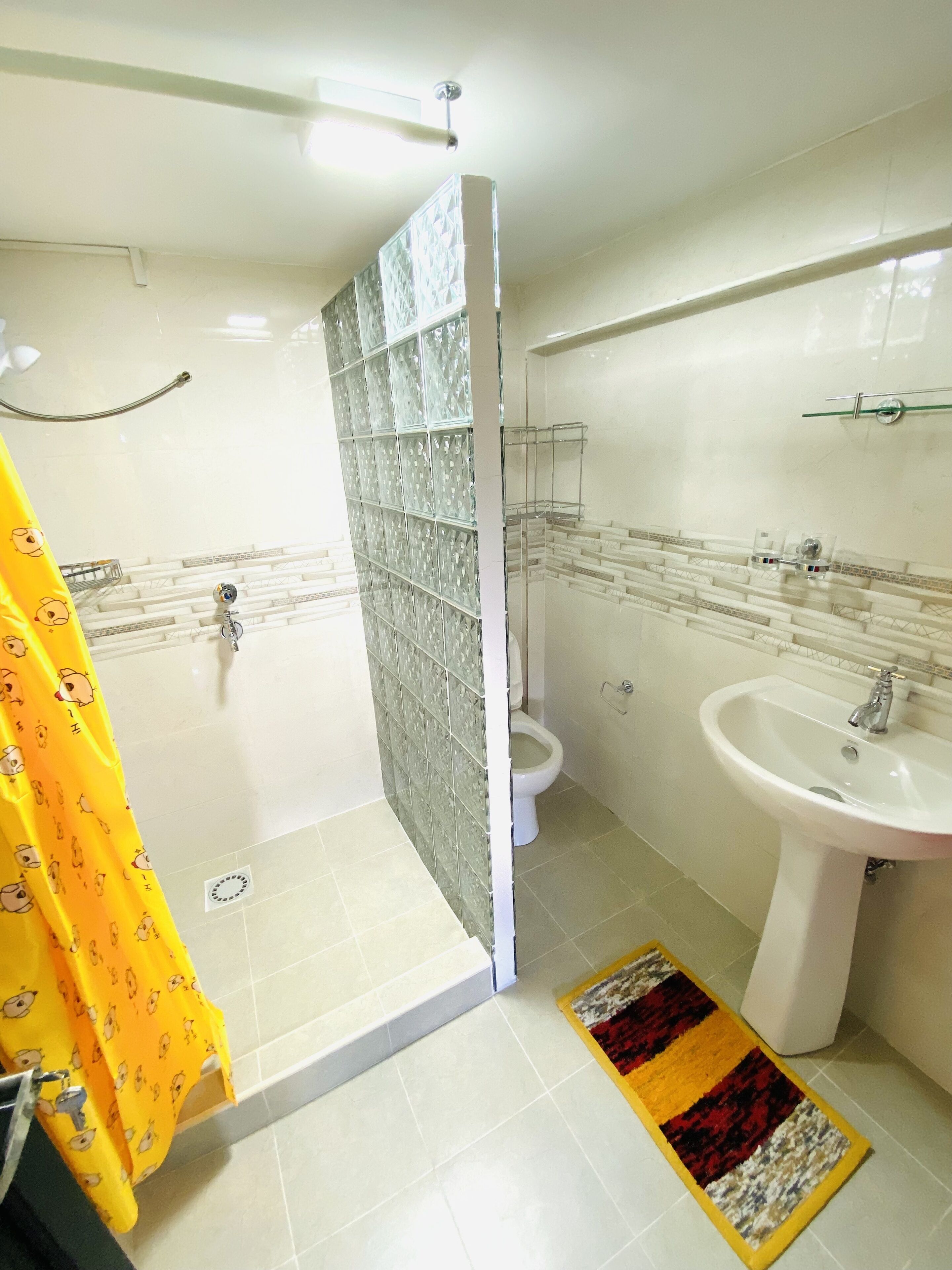 Un baño con ducha, inodoro y lavamanos.