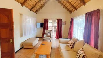 Luxury Suite | Living area | 40-inch LED TV with satellite channels