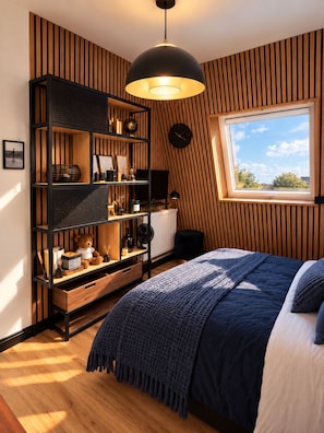 A bedroom with a bed, a large window, a wall-mounted clock, and a bookshelf. - Le Lagon de Léon Studio Cabourg, Feet in the Water, Marcel Proust Promenade (Cabourg)