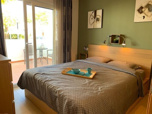 A fresh modern apartment on a lovely garden with a shared pool