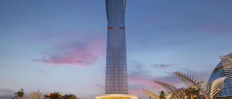 A tall, modern skyscraper with a glass facade and a distinctive rounded top.
