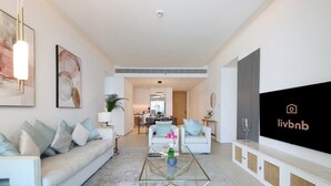 A modern living room with a sofa, coffee table, and artwork.