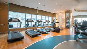 A gym with treadmills, exercise balls, and weight machines.