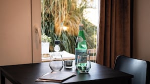 A table with a bottle of Pellegrino water, two glasses, and a menu. - Room-apartments & Rooms Buble - Studio w (Trogir)