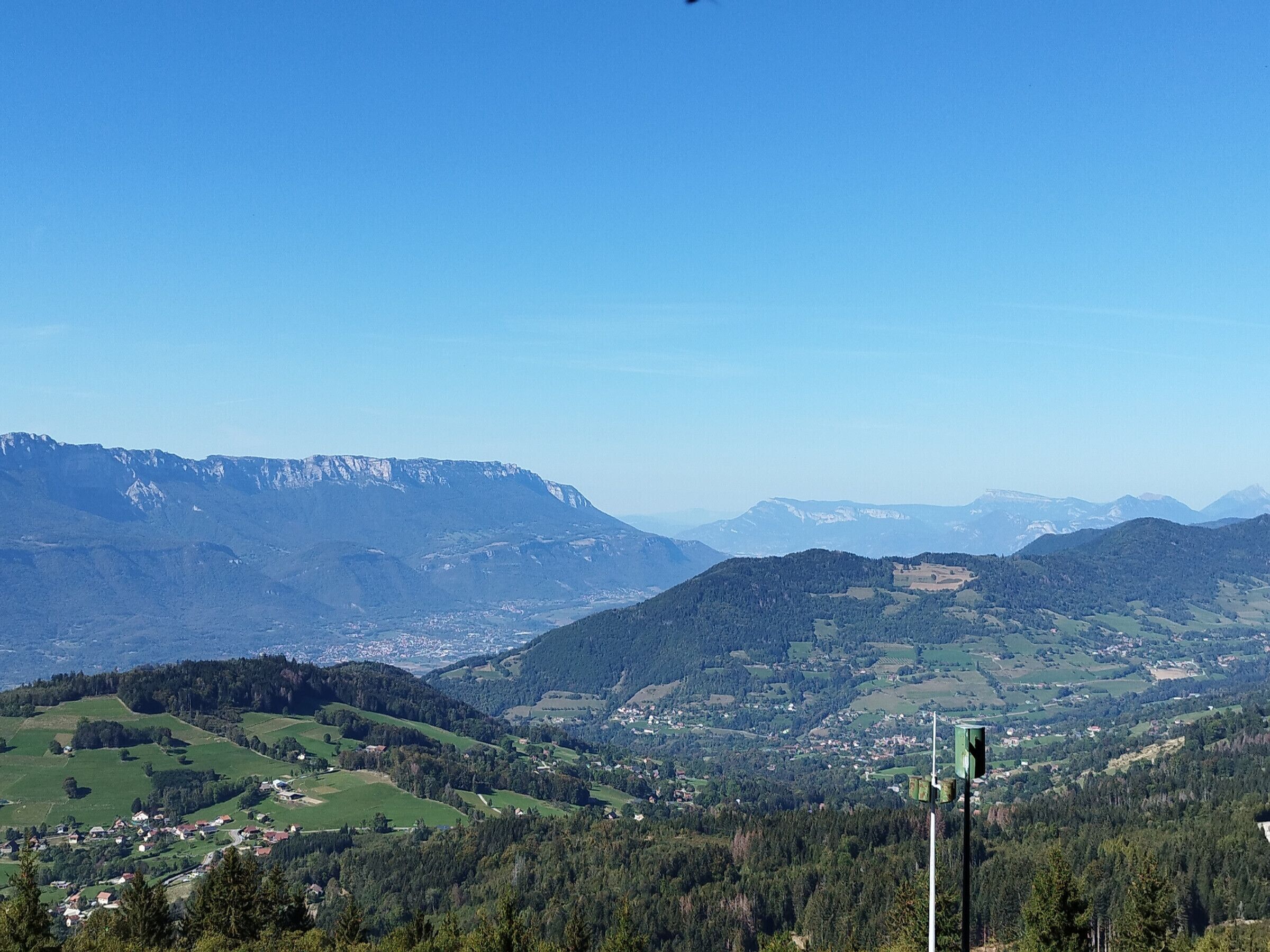 A panoramic view of a mountainous landscape with a small village nestled in the valley.