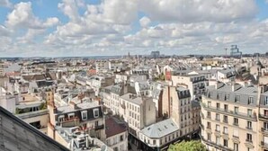 A cityscape with a variety of building styles, including historic and modern architecture.