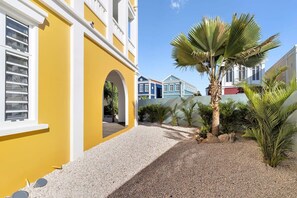 A yellow building with a white window and an arched doorway. - Kas Hira with Lovely Cooling Pool (Kralendijk)