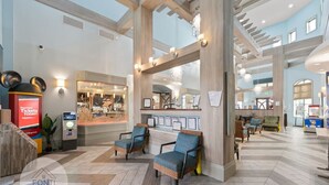 A spacious lobby with high ceilings, wooden beams, and a seating area with blue upholstered chairs. - 1028L Resort 4BR Pool House FREE Grill by Disney (Kissimmee)