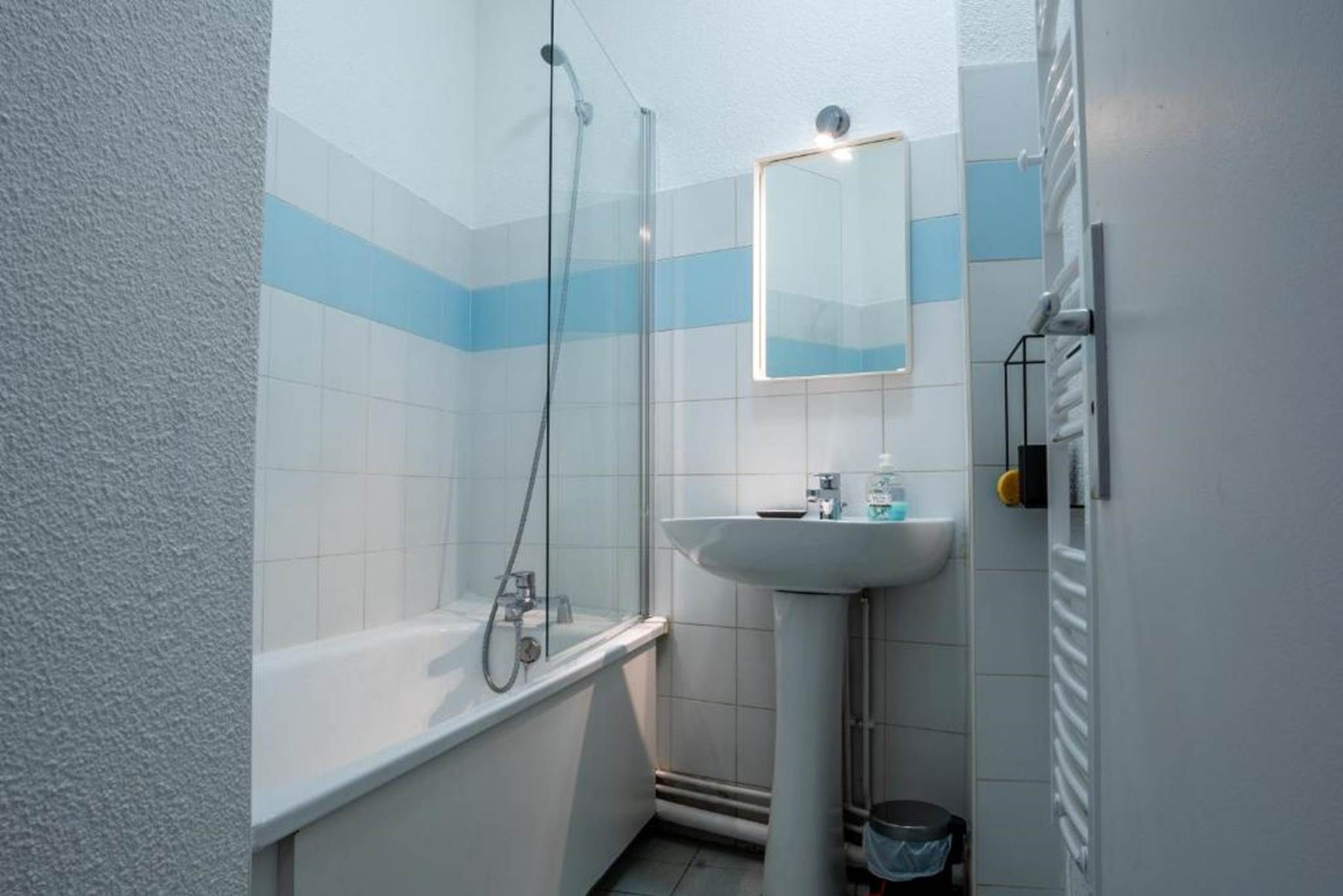 A bathroom with a bathtub, a sink, and a shower.