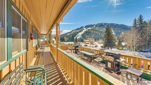 A wooden balcony with a view of a snowy mountain landscape. - Main Street Red River Condo w/ Fireplace & Views! (Red River)