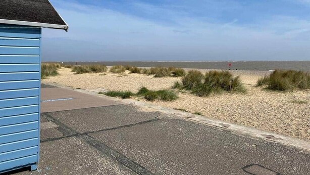 A beachside view with a building, a gravel path, and a sandy beach. - Beach retreat! (Pakefield)