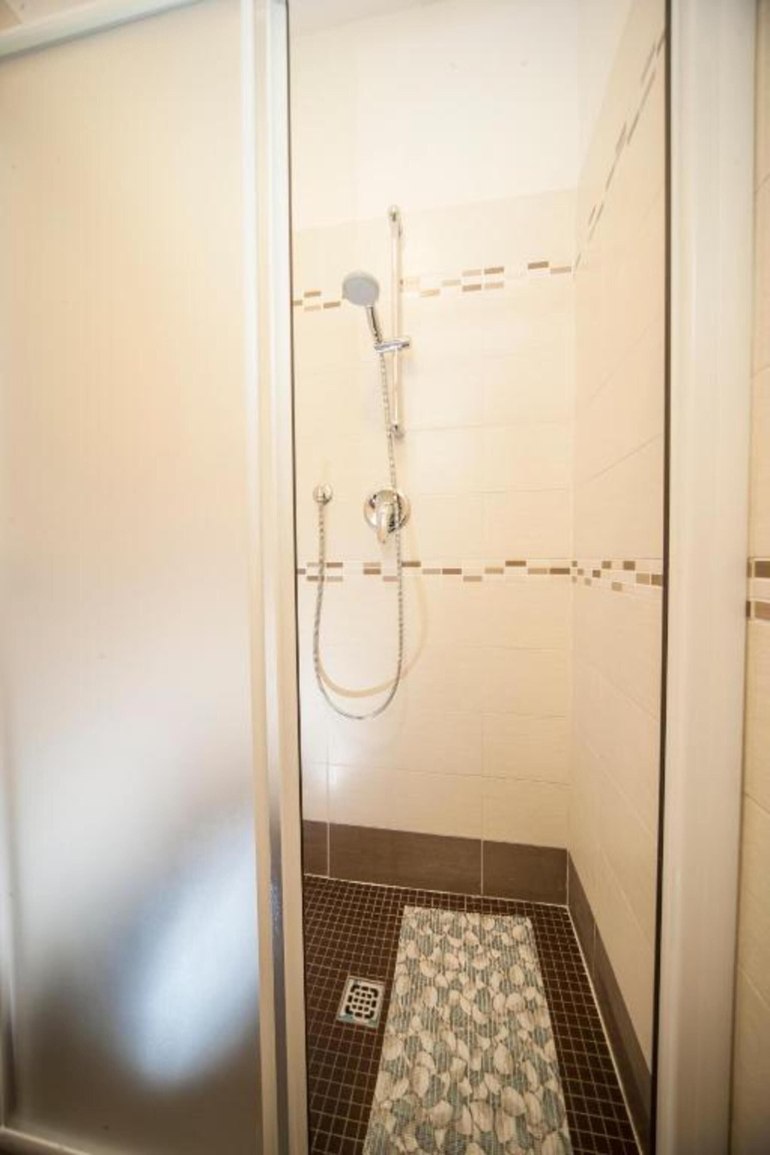 Shower, rainfall showerhead, hair dryer, towels