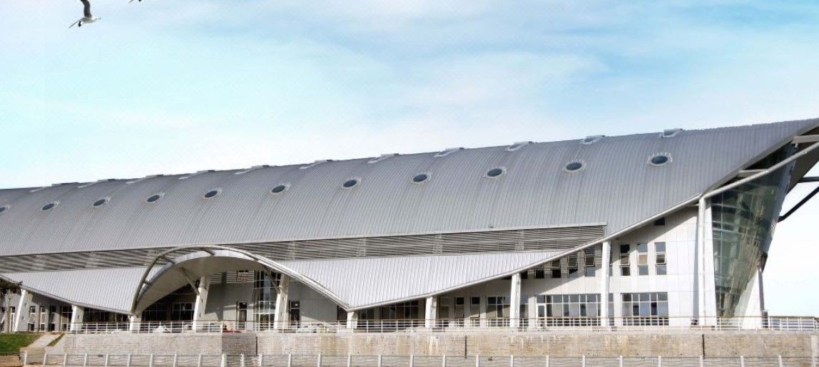 A modern building with a curved roof and large windows.