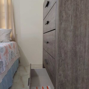 A bedroom with a bed, a dresser, and a nightstand. - Taylor's Escape (Ocho Rios)