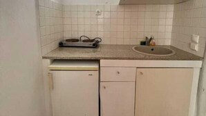 A compact kitchen with a sink, a small refrigerator, and a countertop. - Two-room apartment for 4 people, with (Mikonos)