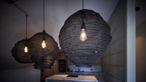 A modern kitchen with pendant lighting, a central island, and bar stools.