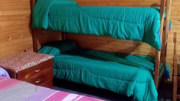 Cozy retreat with a bunk bed, bedside table, and comfortable bed.