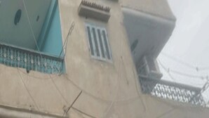 A multi-story building with balconies and windows.
