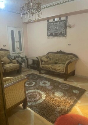 Comfort Apartment | Living area | 32-inch flat-screen TV with satellite channels, fireplace - Country house (Awlad Saqr)