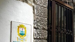 A stone wall with a metal gate and a plaque with a coat of arms. - Residenza Giuseppe (Amalfi)