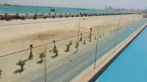 A pool with a clear view of the beach and ocean. - A Luxurious Sea View 1 Bedroom Apartment (Al HIDD)