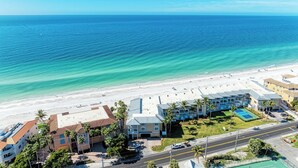 An aerial view of a coastal hotel with multiple buildings, a beach, and a clear blue sky. - Bradenton Beach Club Bliss-2 Bedroom-2 Bathroom Condo-2 Pools-hottub-private Beach Access (Bradenton Beach)