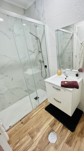 Shower, hair dryer, towels, soap