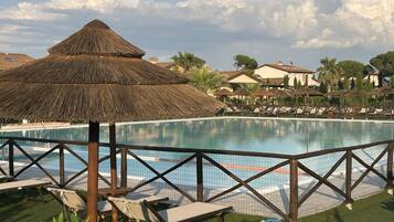 Seasonal outdoor pool, open 9:00 AM to 8:00 PM, pool umbrellas