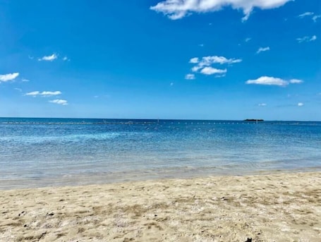 Sun-loungers, beach towels. “Unwind. Relax. Escape.”