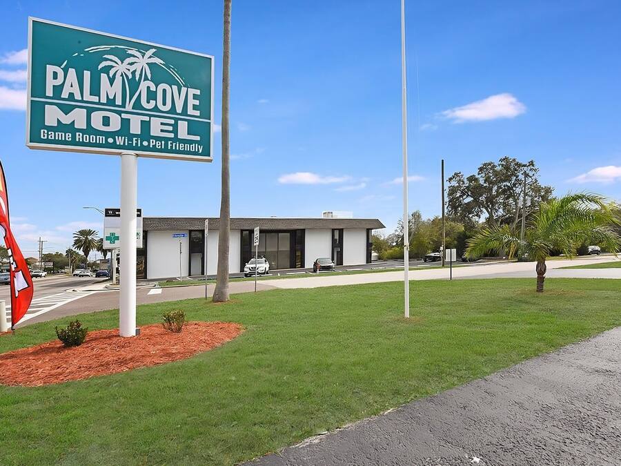 A motel sign with amenities like a game room, Wi-Fi, and pet-friendly policy.