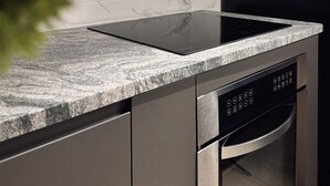 A modern kitchen with a built-in induction cooktop, a dishwasher, and a microwave. - Private Parking• Stylish Elegance •King bed (Pittsburgh)