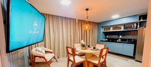 Cozy living space with a dining area, flat-screen TV, and fully equipped kitchen.
