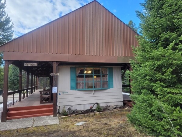 A small, single-story building with a brown roof and a covered porch. - Cozy Island Park retreat close to Yellowstone (Island Park)