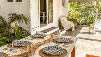 Enjoy a formal dining experience in this beautifully set outdoor space with a mix of natural and man-made elements.