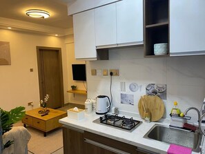 Fridge, microwave, oven, stovetop - 1bedroom Exquisite Apartment in Kilimani by The Manna Stays (Nairobi)