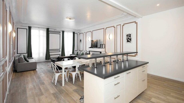 A modern kitchen with a central island, a dining area with chairs, and a sofa. - Daumesnil Grand - Two Bedroom Apartment, Sleeps 6 (Paris)