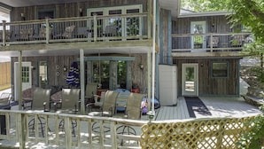 A two-story wooden house with a balcony and a covered porch area. - Making Lake Memories, Water Toys, Launch area /Dock/Slip, Fire pit, parking for group. (Linn Creek)