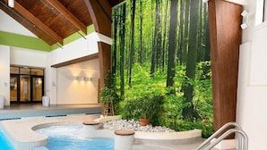An indoor swimming pool with a hot tub, surrounded by a forest-themed mural, and a metal ladder for access. - SugarBear- Pool, AC, Sauna, Gym, Tennis! (Killington)