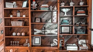 A wooden bookshelf with various decorative items and books.