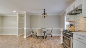 A kitchen with a dining table, chairs, an oven, and a chandelier. - Bailey Vacation Rental, 13 Mi to Downtown Wilson (Bailey)