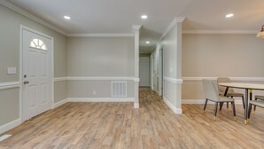 A hallway with wooden flooring, white walls, and a dining area with a table and chairs. - Bailey Vacation Rental, 13 Mi to Downtown Wilson (Bailey)