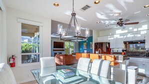A modern kitchen with white cabinets, a granite countertop, and a ceiling fan. - Cathedral City Home w/ Private Pool - Near Golf (Cathedral City)