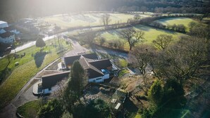 An aerial view of a rural area with houses, roads, and open fields. - Suite 3 - Sleeping Giant Hotel - Pen Y Cae Inn (Swansea Valley)