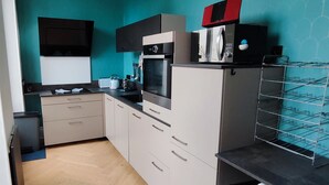 A compact kitchen with a microwave, oven, and a small countertop area.