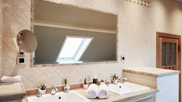 A bathroom with a large mirror, two sinks, wooden cabinets, and a tiled backsplash.